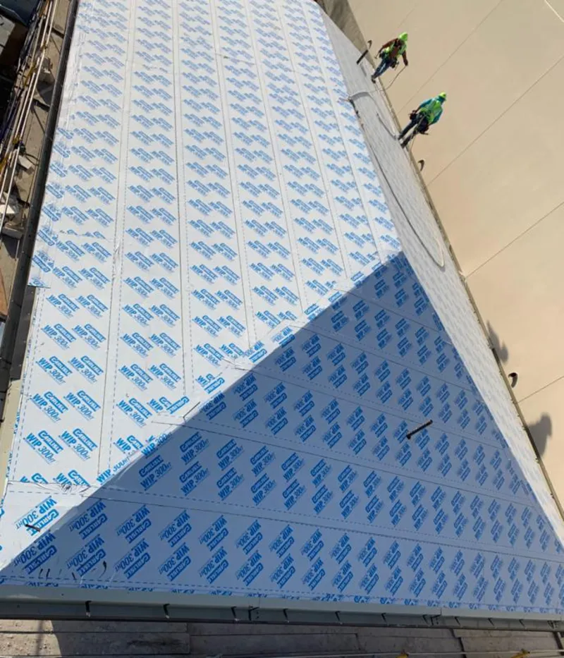 Professional roofers installing underlayment on a metal roof in Sterling